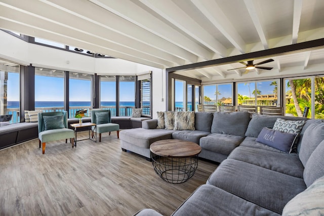 sunroom featuring beam ceiling, a water view, and ceiling fan