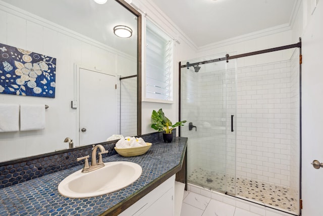 bathroom featuring vanity, crown molding, and walk in shower