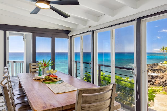 sunroom featuring vaulted ceiling with beams, a water view, and ceiling fan