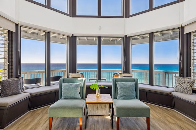 sunroom / solarium featuring a water view