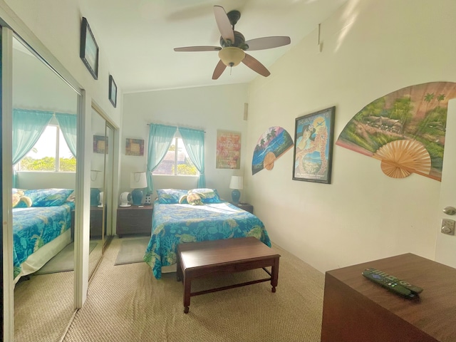 bedroom with lofted ceiling, carpet, multiple windows, and ceiling fan