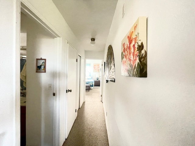 hallway with carpet flooring