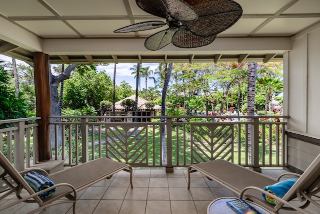 sunroom / solarium featuring ceiling fan