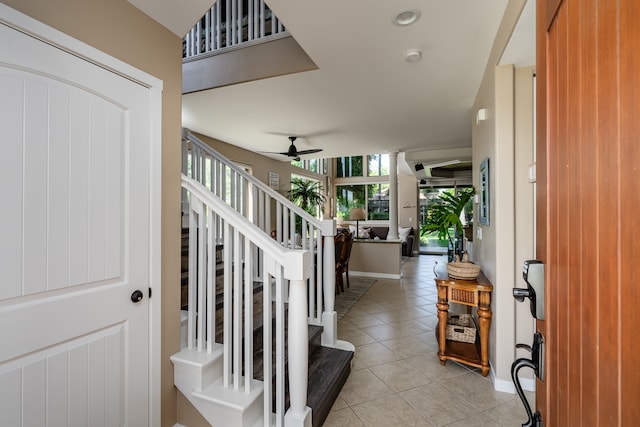 tiled foyer featuring ceiling fan