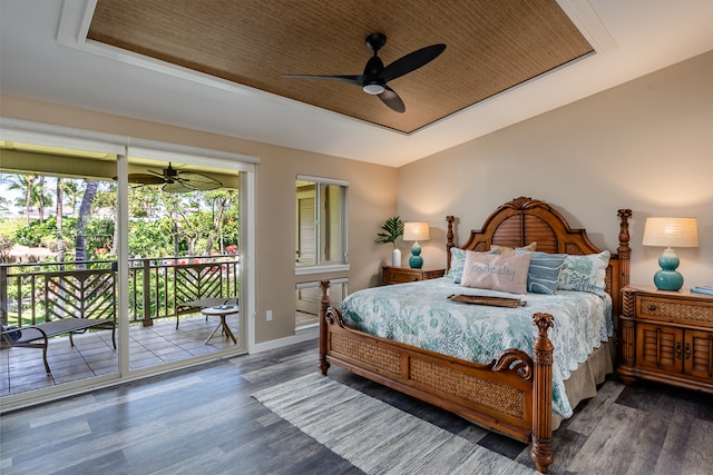 bedroom featuring access to exterior, dark hardwood / wood-style flooring, a raised ceiling, and ceiling fan