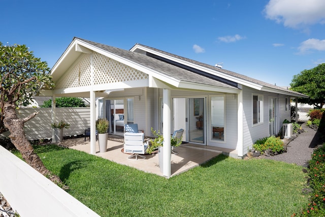 rear view of house with a yard, central AC, and a patio area