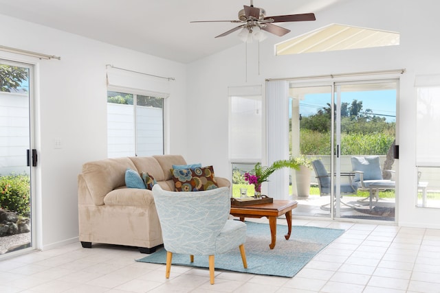 living room with vaulted ceiling, ceiling fan, and light tile patterned floors