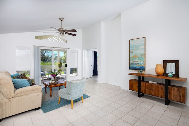 living room with light tile patterned floors, high vaulted ceiling, and ceiling fan