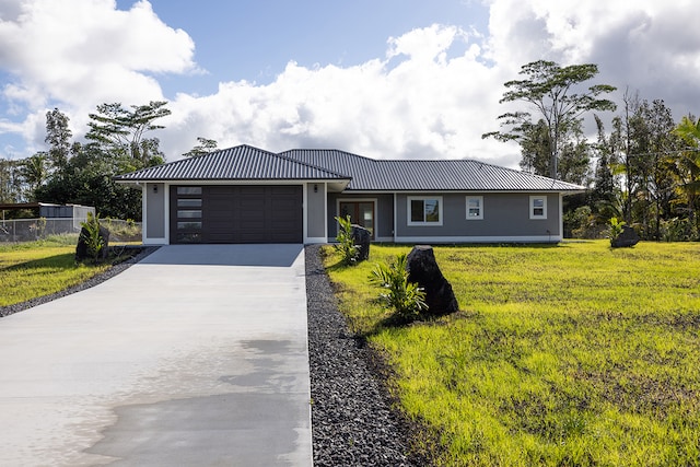 view of front facade featuring a garage and a front lawn