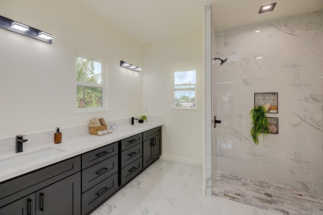 bathroom with vanity and tiled shower