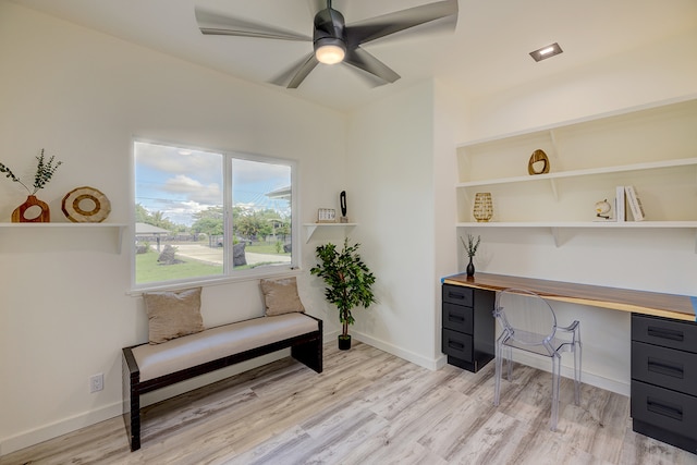 office featuring ceiling fan, built in desk, and light hardwood / wood-style floors