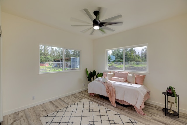 bedroom with ceiling fan and light hardwood / wood-style floors