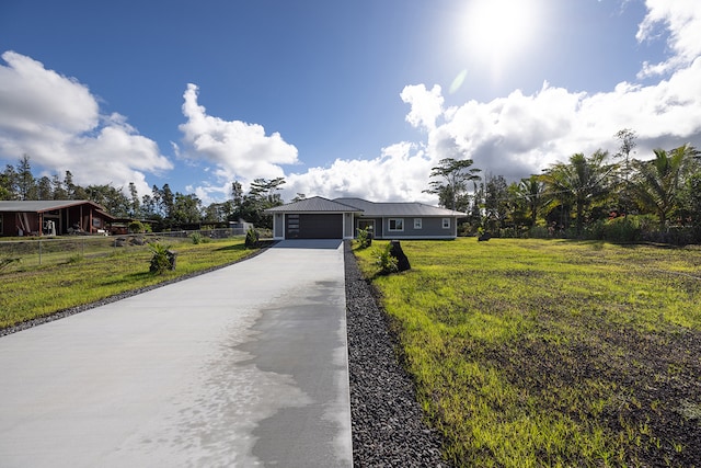 single story home featuring a front yard and a garage