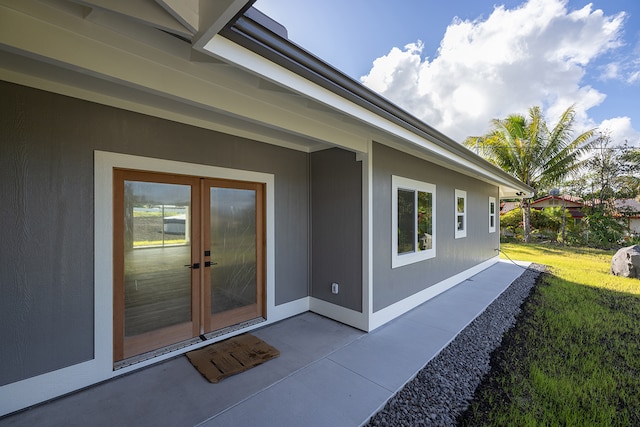 property entrance with a patio area and a yard