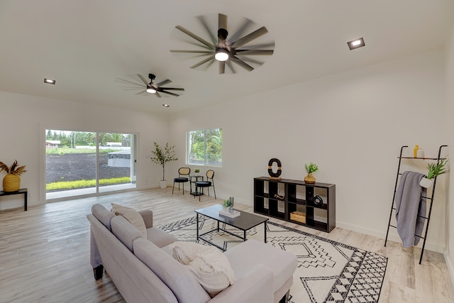 living room with light hardwood / wood-style floors and ceiling fan