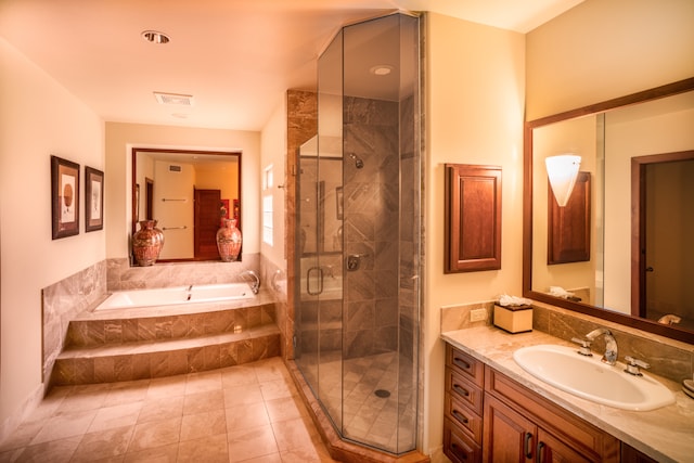 bathroom featuring vanity, tile patterned floors, and separate shower and tub