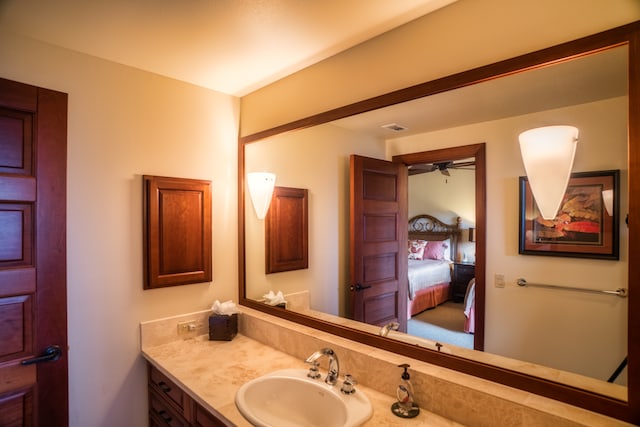 bathroom featuring vanity and ceiling fan