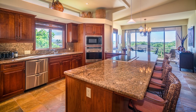 kitchen with tasteful backsplash, black appliances, a kitchen island, and a breakfast bar area