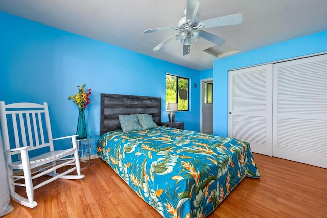 bedroom with hardwood / wood-style flooring, ceiling fan, and a closet