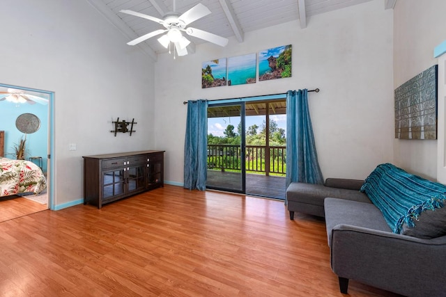 living room with beamed ceiling, ceiling fan, light wood-type flooring, and high vaulted ceiling