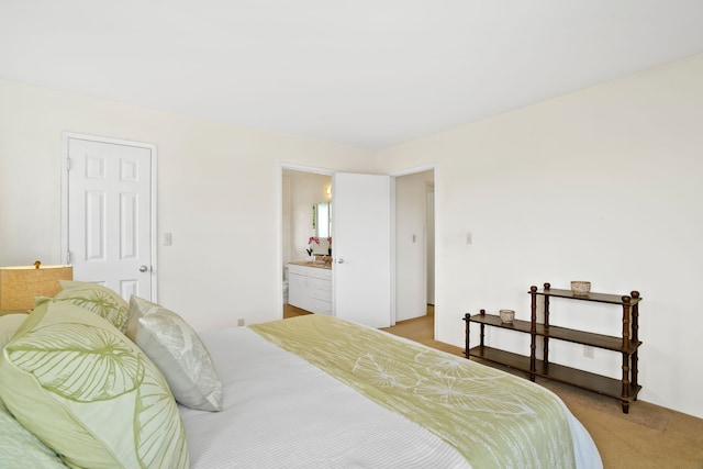 carpeted bedroom with ensuite bathroom