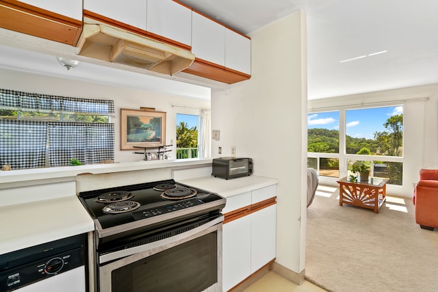 kitchen featuring white cabinets, stainless steel range with electric cooktop, light carpet, and white dishwasher