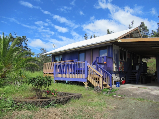 exterior space featuring a deck and a carport