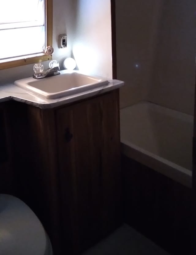 bathroom featuring vanity and toilet