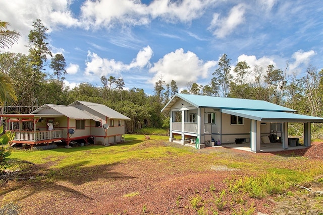 view of side of home featuring a patio area and a yard