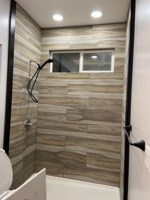 bathroom with a tile shower