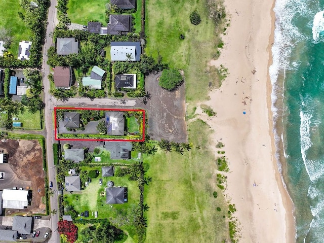 birds eye view of property featuring a view of the beach and a water view