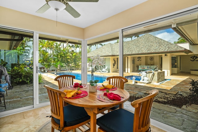 sunroom / solarium featuring a wealth of natural light and ceiling fan