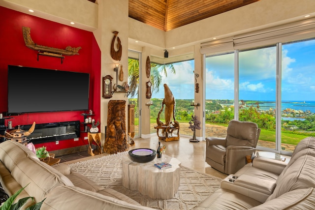 living room with high vaulted ceiling, plenty of natural light, and a water view