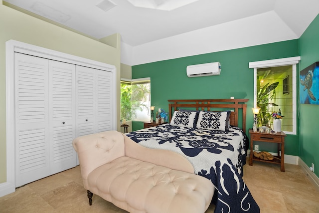 bedroom with an AC wall unit and a closet