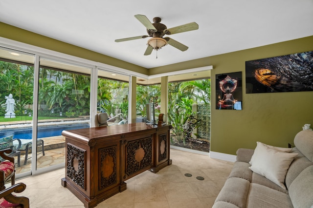 tiled home office with ceiling fan and plenty of natural light