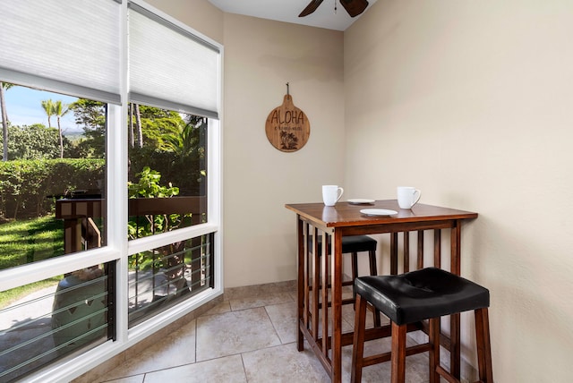 sunroom featuring ceiling fan