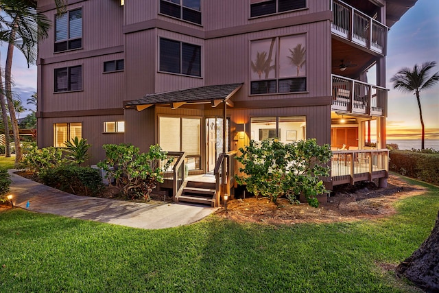 exterior space with a balcony and a yard