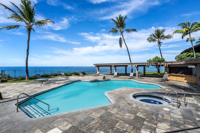 view of pool with a patio area, a water view, and a community hot tub