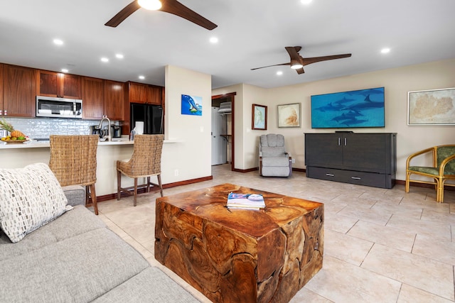 living room with light tile patterned flooring and ceiling fan