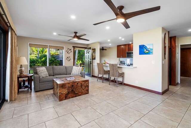 living room featuring ceiling fan and light tile patterned floors