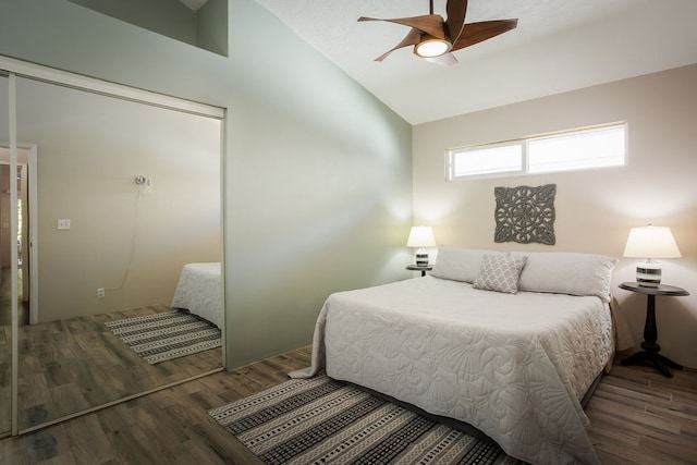 bedroom with hardwood / wood-style floors, ceiling fan, and vaulted ceiling