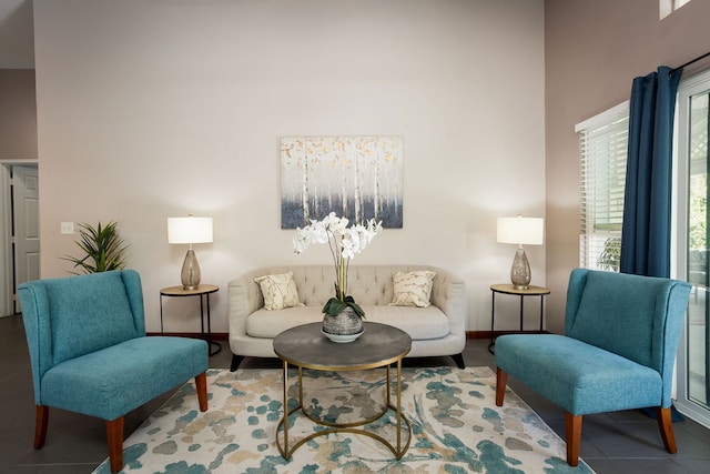 living room with tile patterned flooring and a towering ceiling