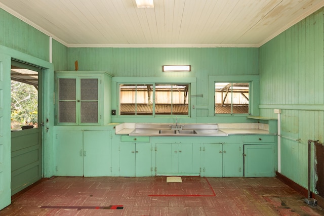 kitchen featuring a sink, green cabinetry, a wealth of natural light, and light countertops