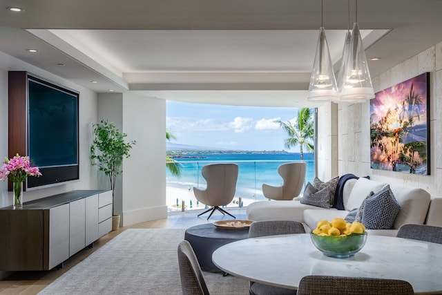 interior space featuring light wood-type flooring, a water view, and a notable chandelier