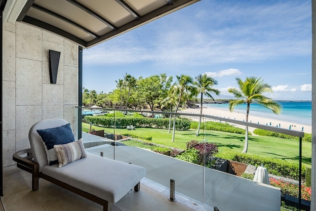 balcony featuring a view of the beach and a water view