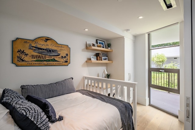 bedroom with light hardwood / wood-style floors and access to outside