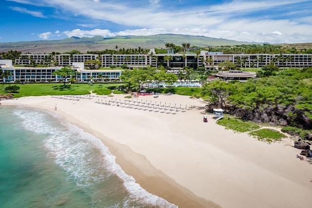 aerial view featuring a water and mountain view and a beach view