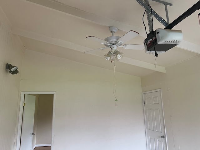 interior details with ceiling fan and a garage door opener