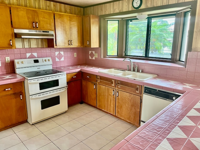 kitchen featuring sink, white appliances, ventilation hood, tile counters, and decorative backsplash