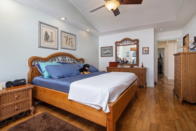 bedroom with ceiling fan, dark hardwood / wood-style floors, and lofted ceiling